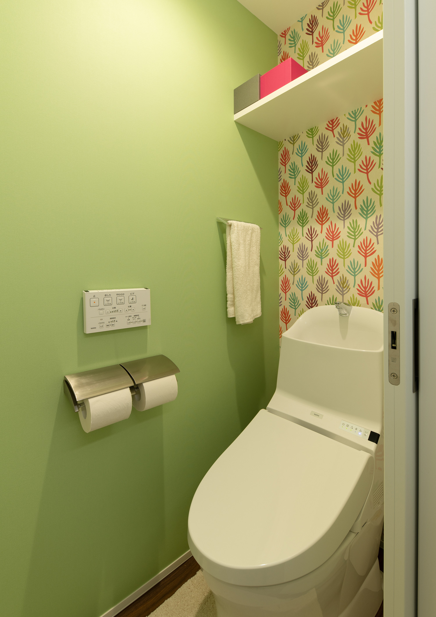 緑色のクロスや柄のクロスが設けられたトイレ・デザイン住宅
