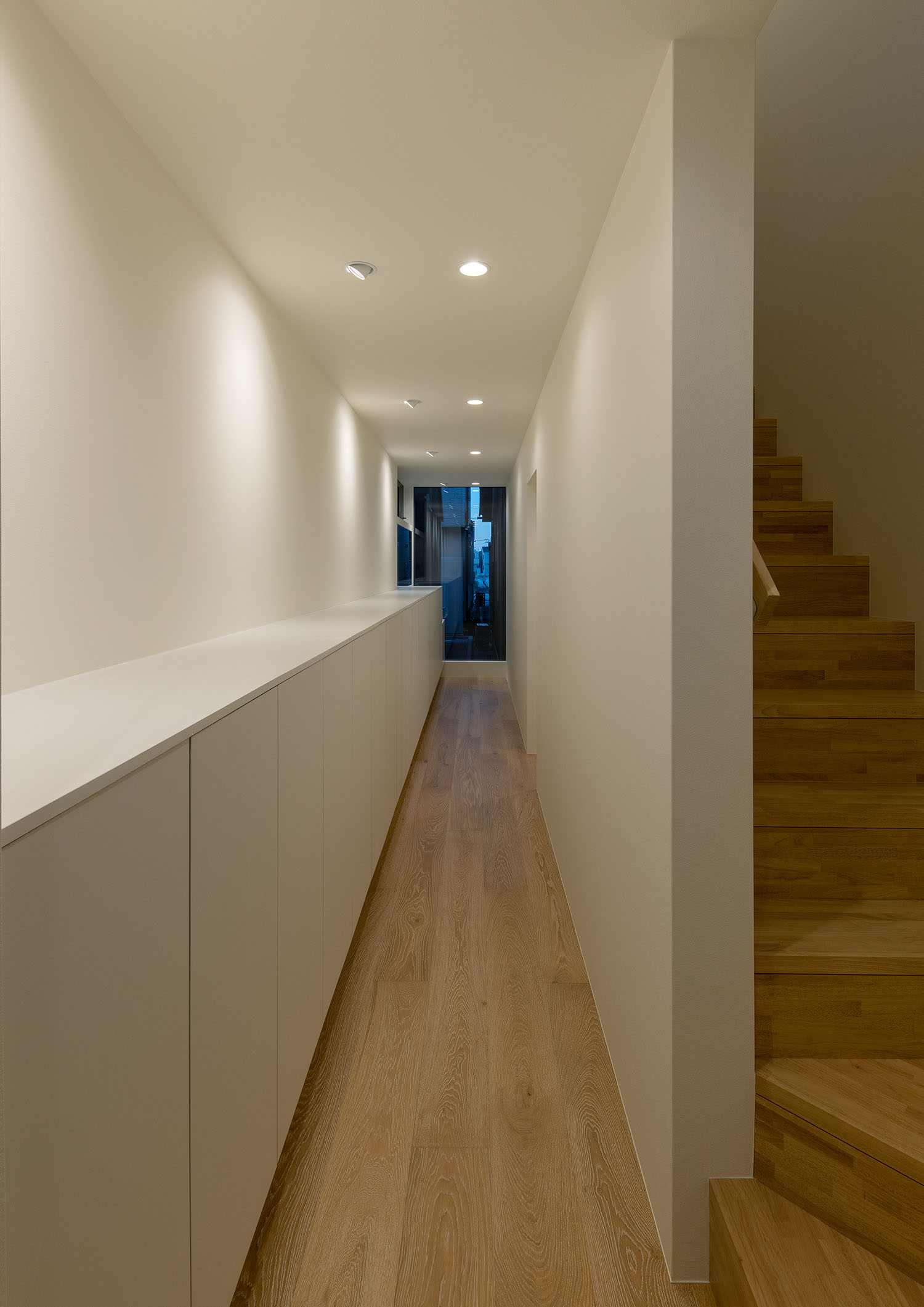 木製の箱型階段から廊下へと繋がる様子・フリーダムアーキテクツの事例