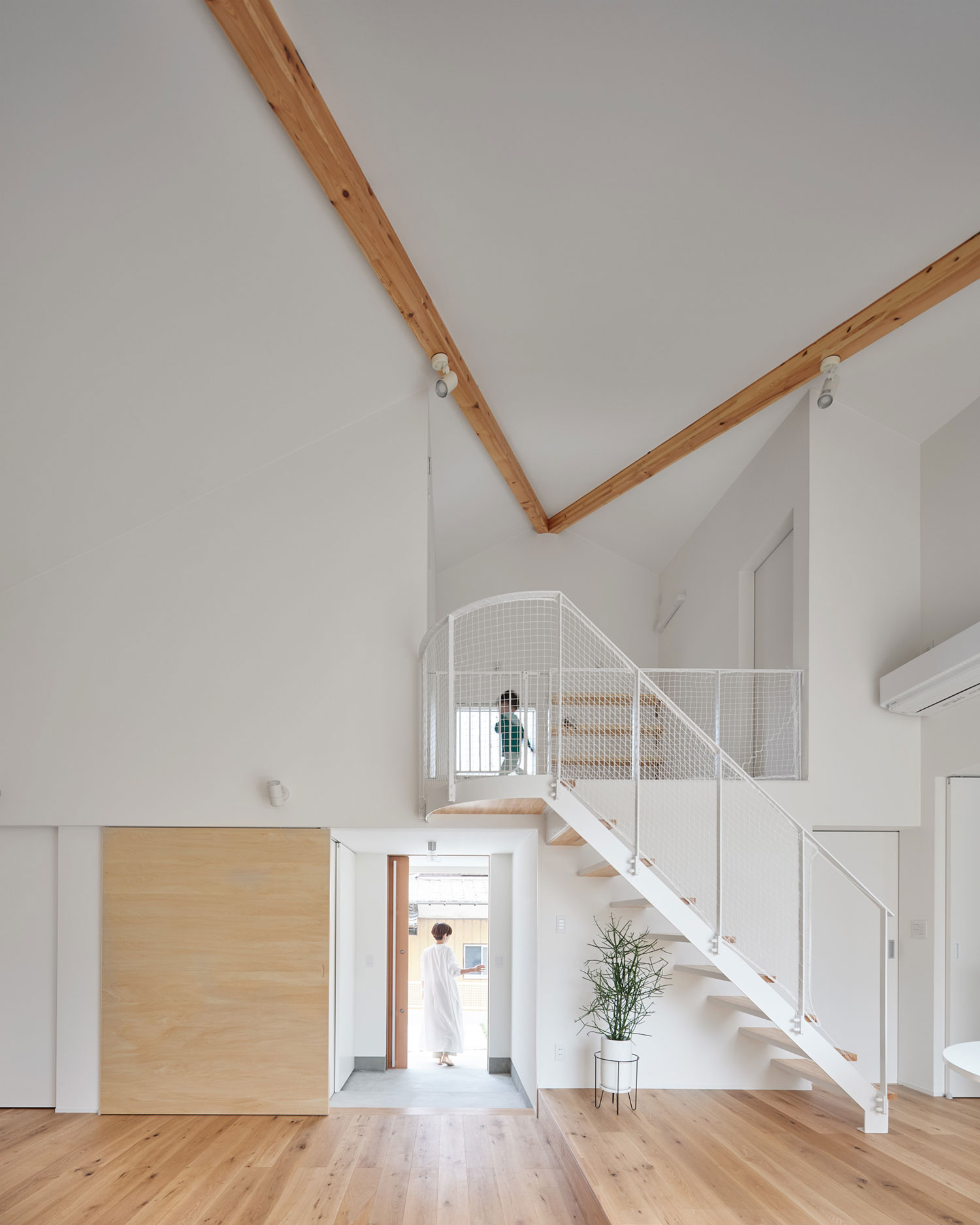 白を基調とした空間にリビングイン階段がある様子・フリーダムアーキテクツの事例