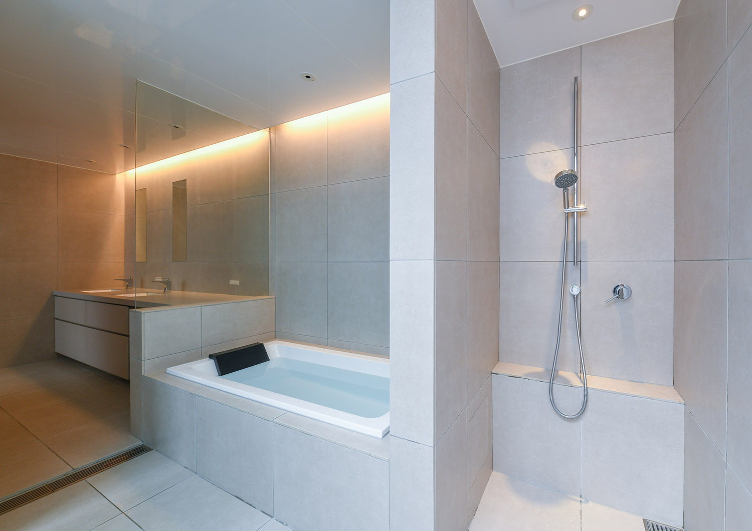 バスタブとシャワー室が壁で仕切られたホテルライクなタイルの浴室・デザイン住宅
